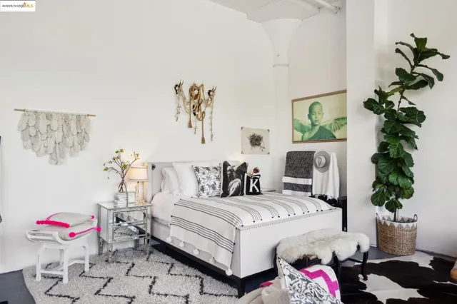 a bedroom with a bed and a potted plant