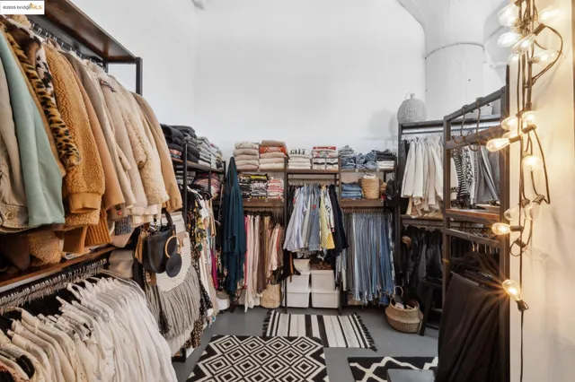 a view of walk in closet with clothes
