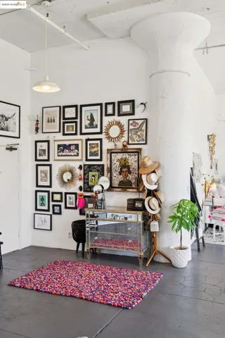 a living room with furniture a rug and white walls
