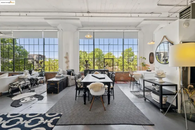 a living room with furniture a lamp and a potted plant