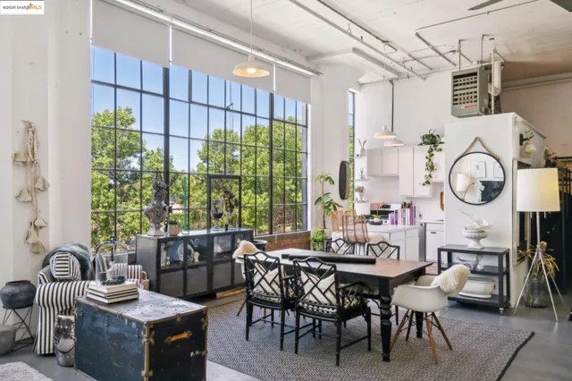 a dining room with furniture a rug and a large window