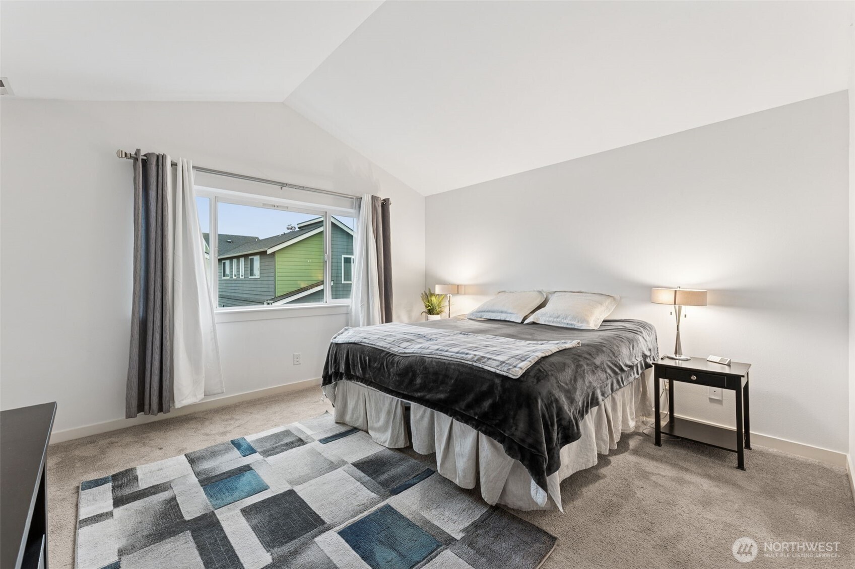 845 Southwest 96th Place Seattle, WA 98106 - Photo 15 of 24 a bedroom with a bed and a lamp on table