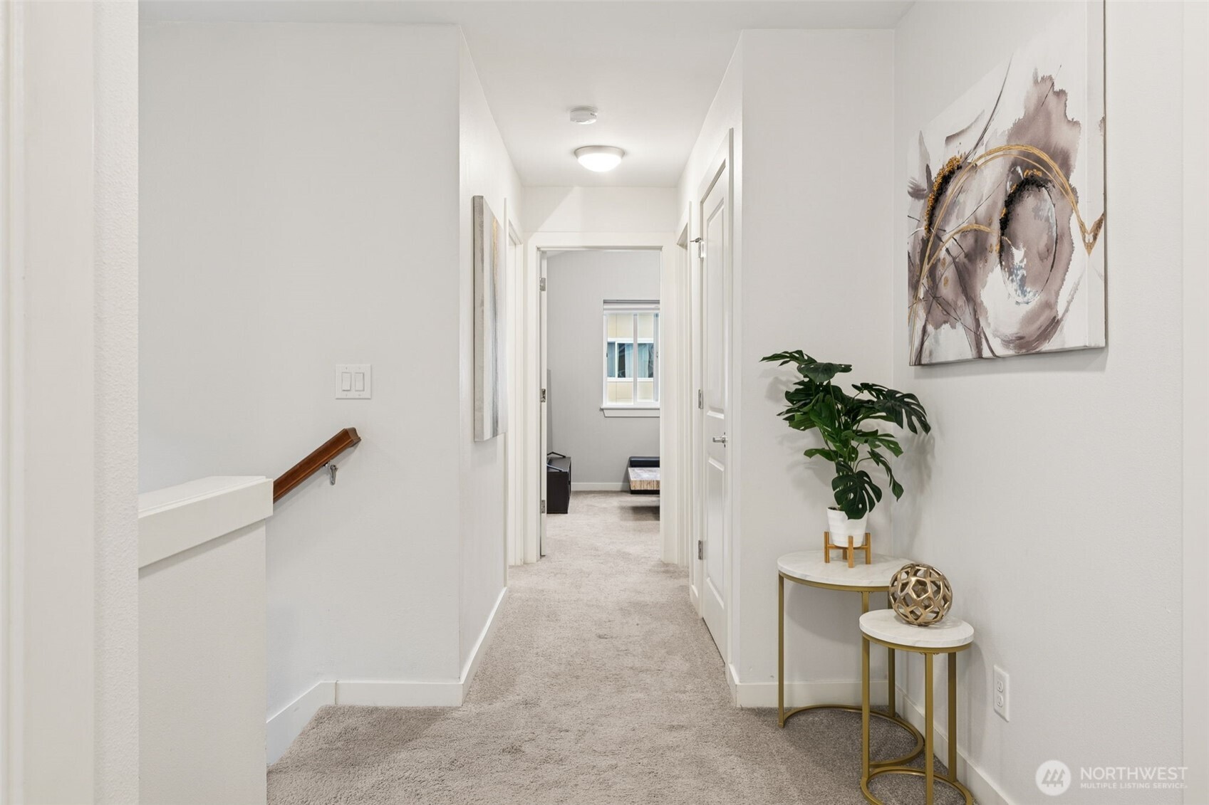 845 Southwest 96th Place Seattle, WA 98106 - Photo 20 of 24 a view of a hallway with paintings on the wall