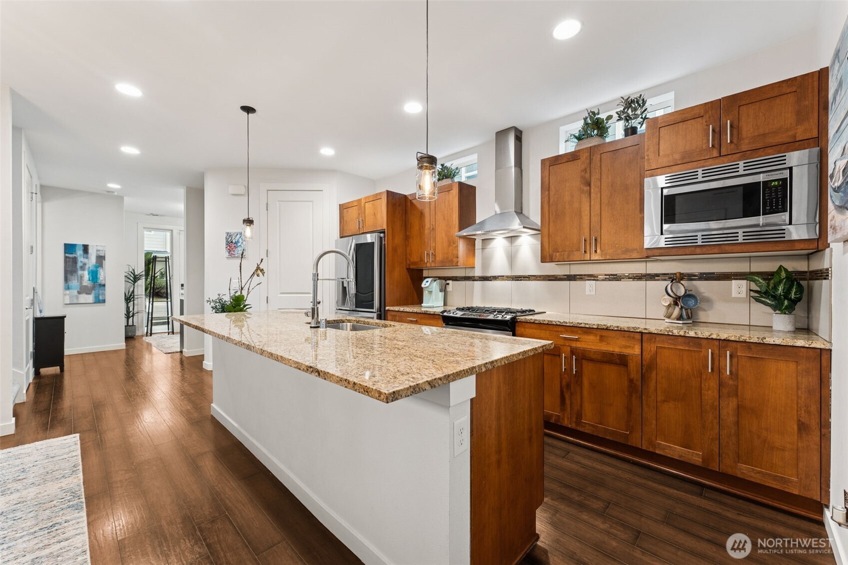 845 Southwest 96th Place Seattle, WA 98106 - Photo 6 of 24 a kitchen with stainless steel appliances a sink stove and wooden floor