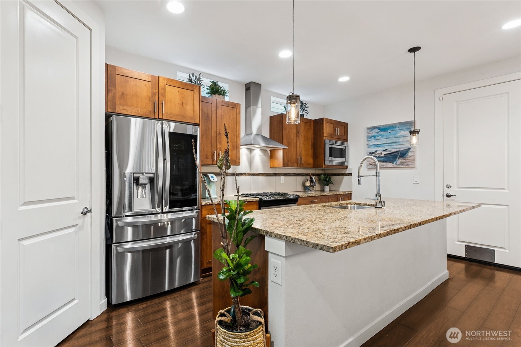 845 Southwest 96th Place Seattle, WA 98106 - Photo 9 of 24 a kitchen with stainless steel appliances granite countertop a sink refrigerator and microwave
