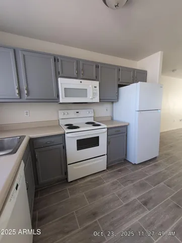 a kitchen with a stove a sink and a refrigerator