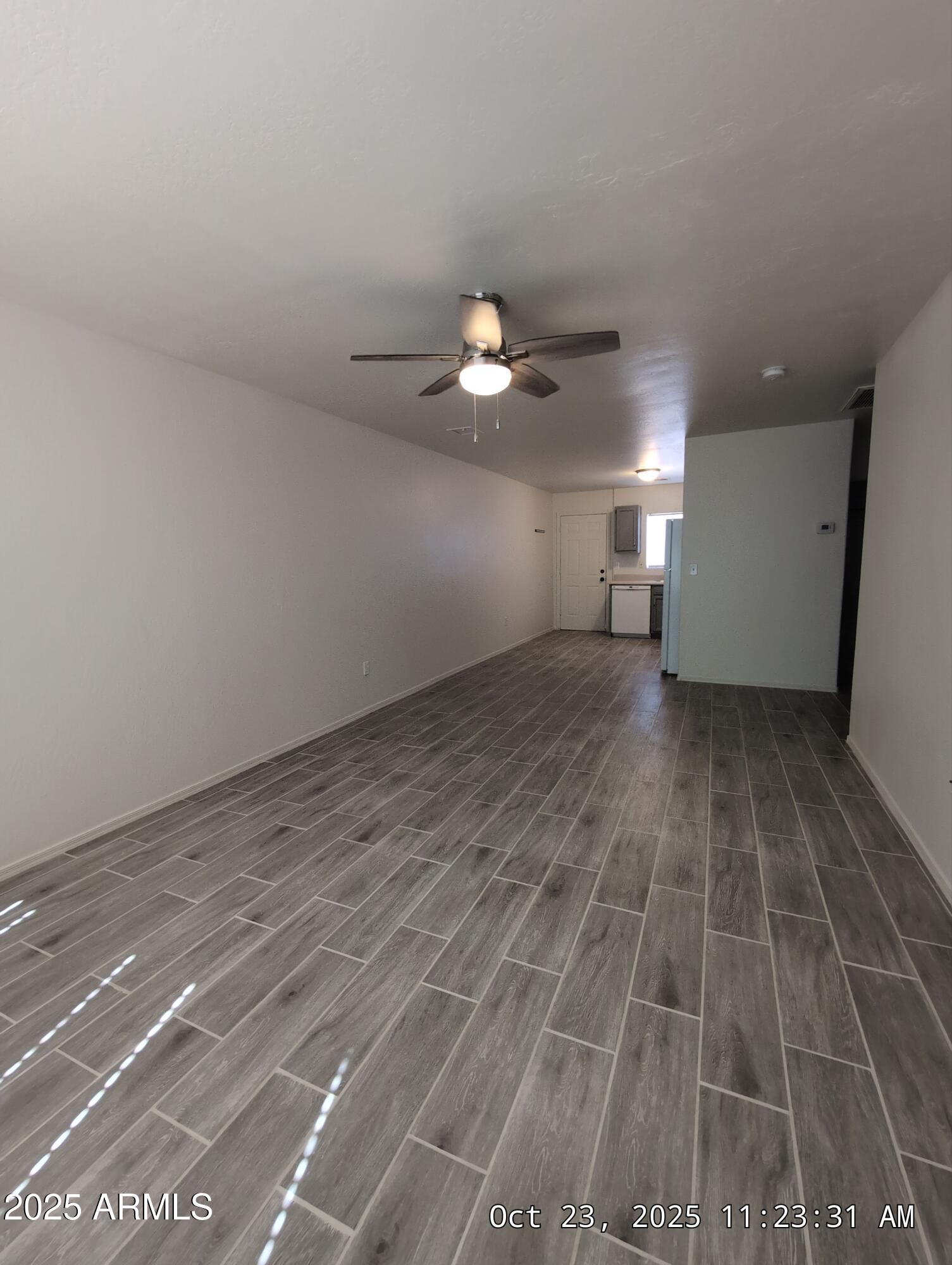 9978 West Century Drive, Unit B Arizona City, AZ 85123 - Photo 5 of 11 a view of a room with a ceiling fan and hardwood floor