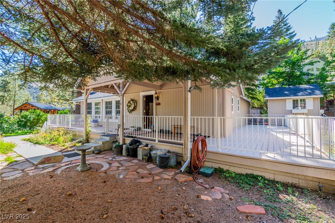 4063 Zugspitz Way Mount Charleston, NV 89124 - Photo 10 of 89 View of front facade with a wooden deck and an outdoor structure