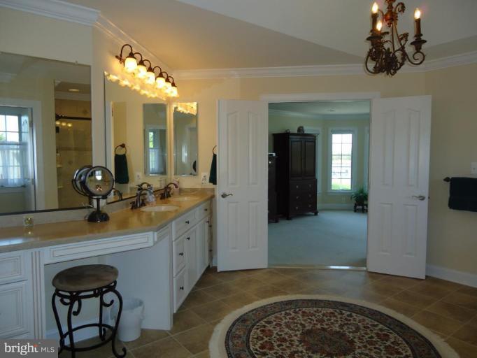 230 Bentons Pleasure Road Chester, MD 21619 - Photo 13 of 30 a bathroom with a sink a vanity and a mirror
