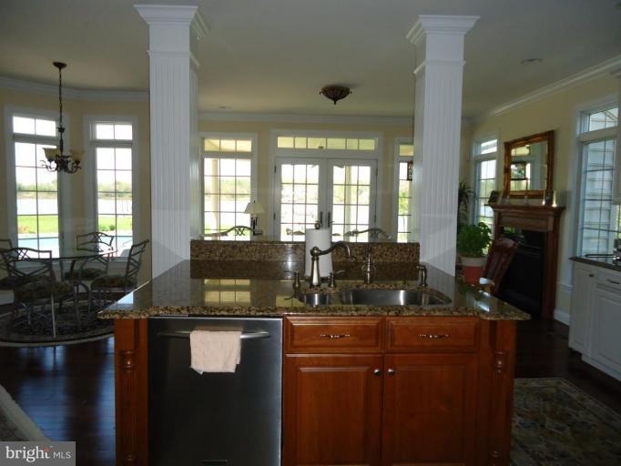 230 Bentons Pleasure Road Chester, MD 21619 - Photo 19 of 30 a kitchen with granite countertop a sink a counter top space and living room