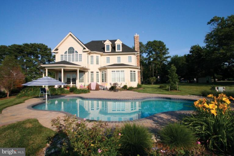 230 Bentons Pleasure Road Chester, MD 21619 - Photo 3 of 30 a front view of a house with swimming pool having outdoor seating