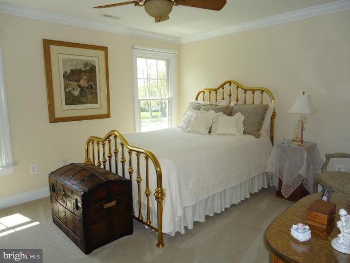 230 Bentons Pleasure Road Chester, MD 21619 - Photo 27 of 30 a bedroom with a bed and a couch