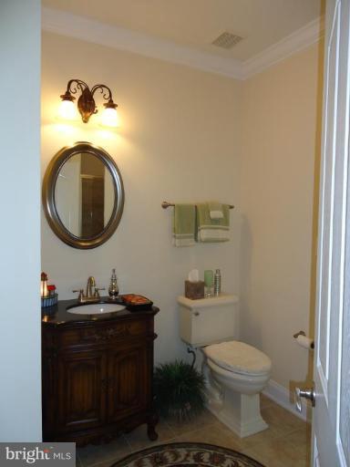 230 Bentons Pleasure Road Chester, MD 21619 - Photo 28 of 30 a bathroom with a toilet a sink and a mirror