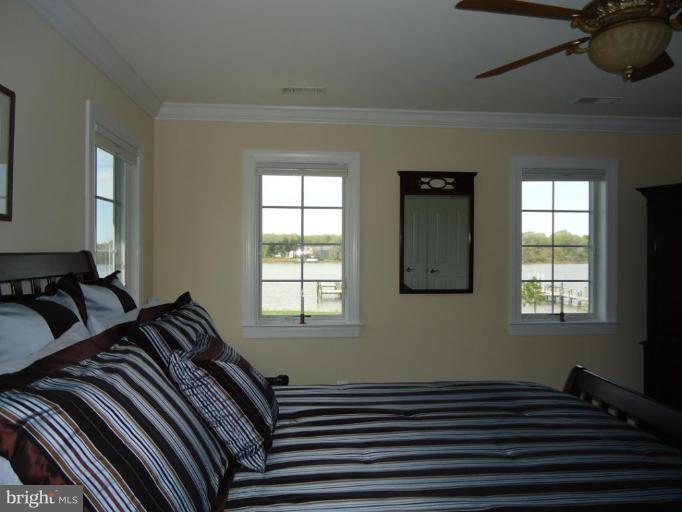 230 Bentons Pleasure Road Chester, MD 21619 - Photo 30 of 30 a bed sitting in a bedroom next to a window