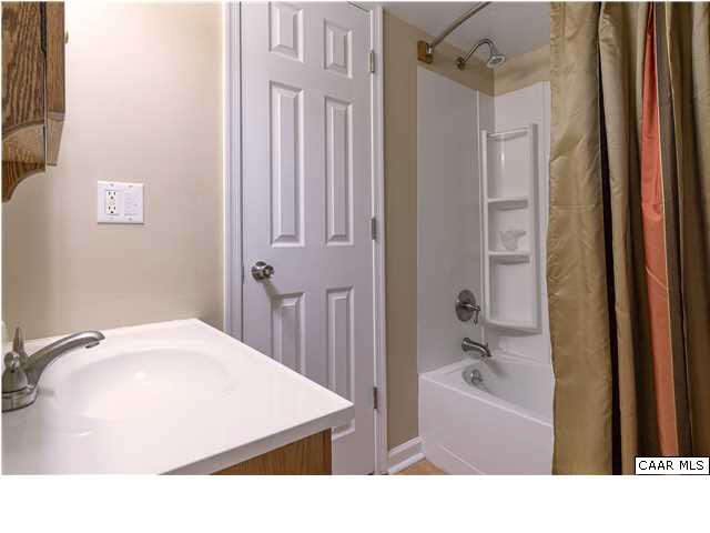1144 Meriwether Street Charlottesville, VA 22902 - Photo 12 of 18 a bathroom with a tub sink and a mirror