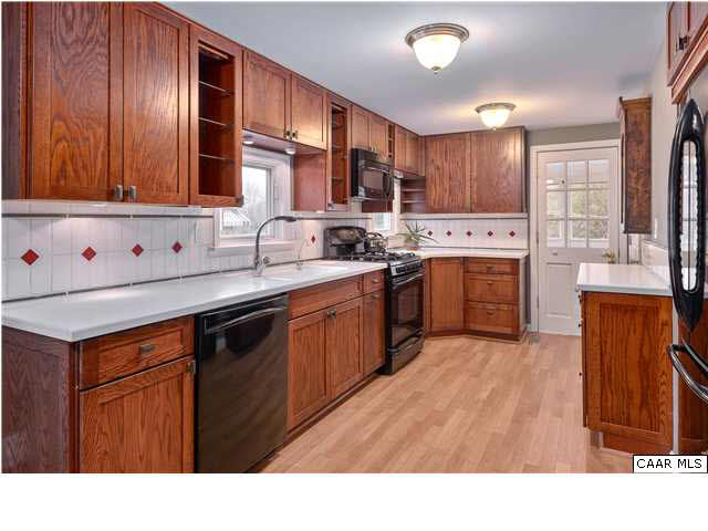 1144 Meriwether Street Charlottesville, VA 22902 - Photo 4 of 18 a kitchen with stainless steel appliances granite countertop a stove a sink dishwasher and a refrigerator