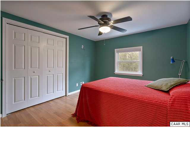 1144 Meriwether Street Charlottesville, VA 22902 - Photo 7 of 18 a bedroom with a bed and a chandelier