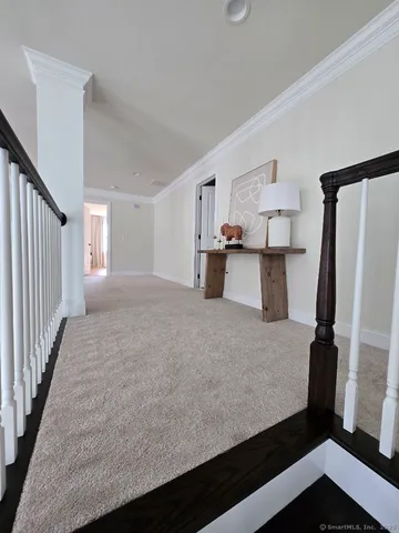 a view of a kitchen with fridge and wooden floor