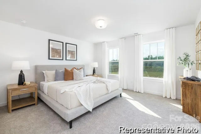 a bedroom with a bed and glass window