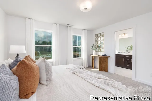 a bedroom with a large bed and a window