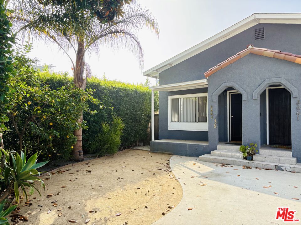 3659 6th Avenue, Unit 3661 1/2 Los Angeles, CA 90018 - Photo 2 of 23 a front view of a house with a yard