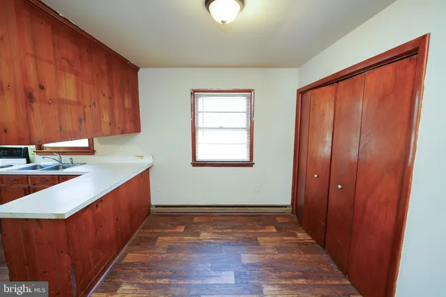 a view of a kitchen with wooden floor and a sink