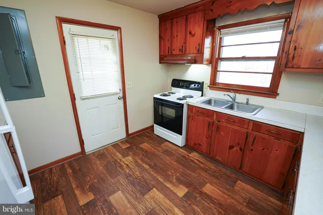 a kitchen with stainless steel appliances granite countertop a refrigerator a sink and a window