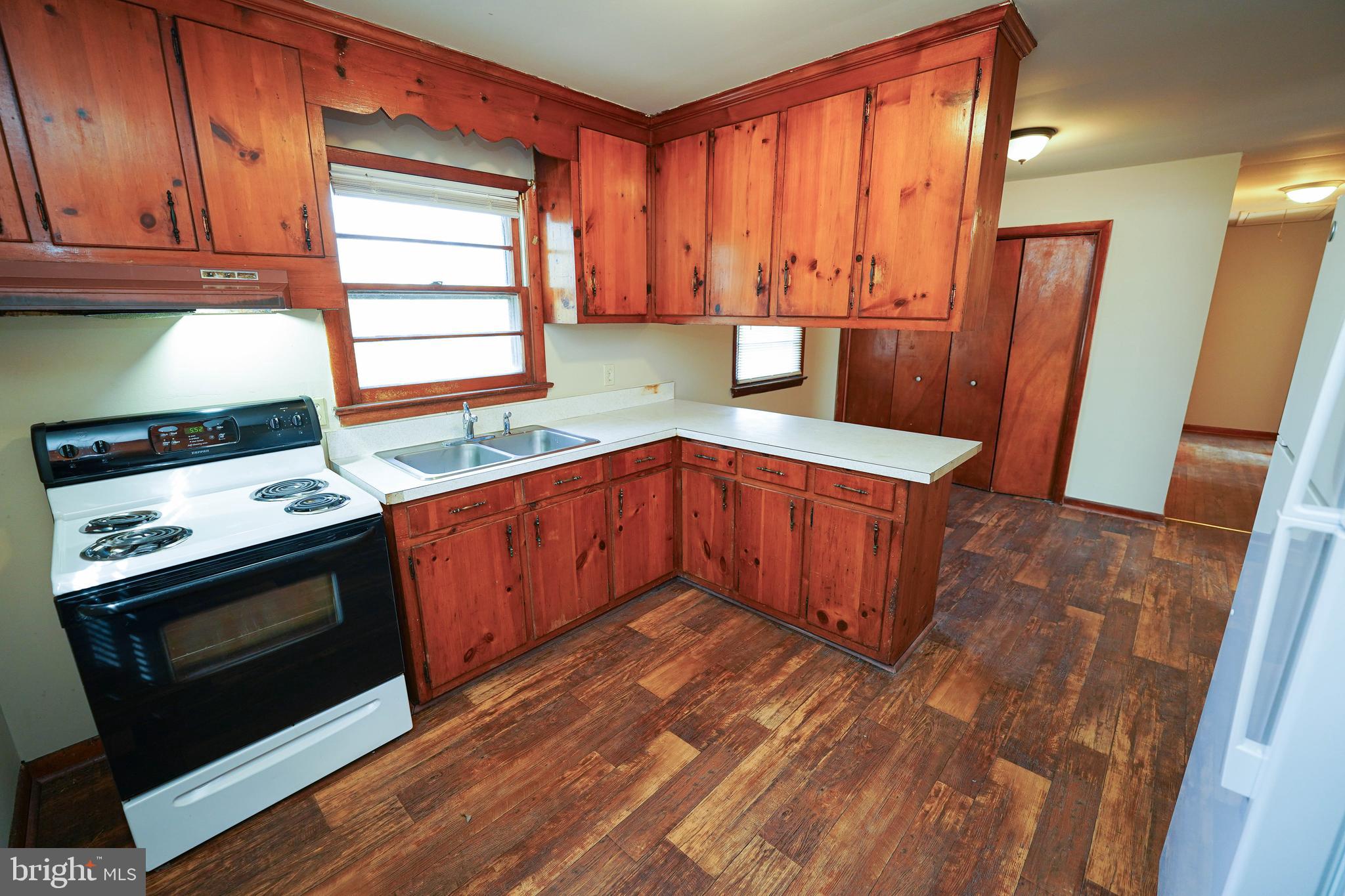5746 Rip Wil Drive Salisbury, MD 21804 - Photo 19 of 35 a kitchen with stainless steel appliances granite countertop a stove a sink and a microwave