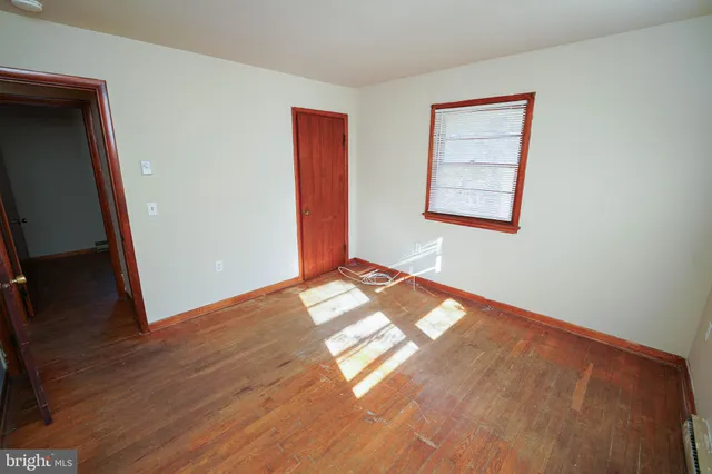 a view of an empty room and wooden floor