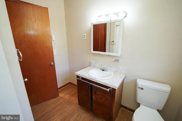 a bathroom with a sink toilet and mirror