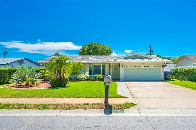 a front view of house with yard and green space