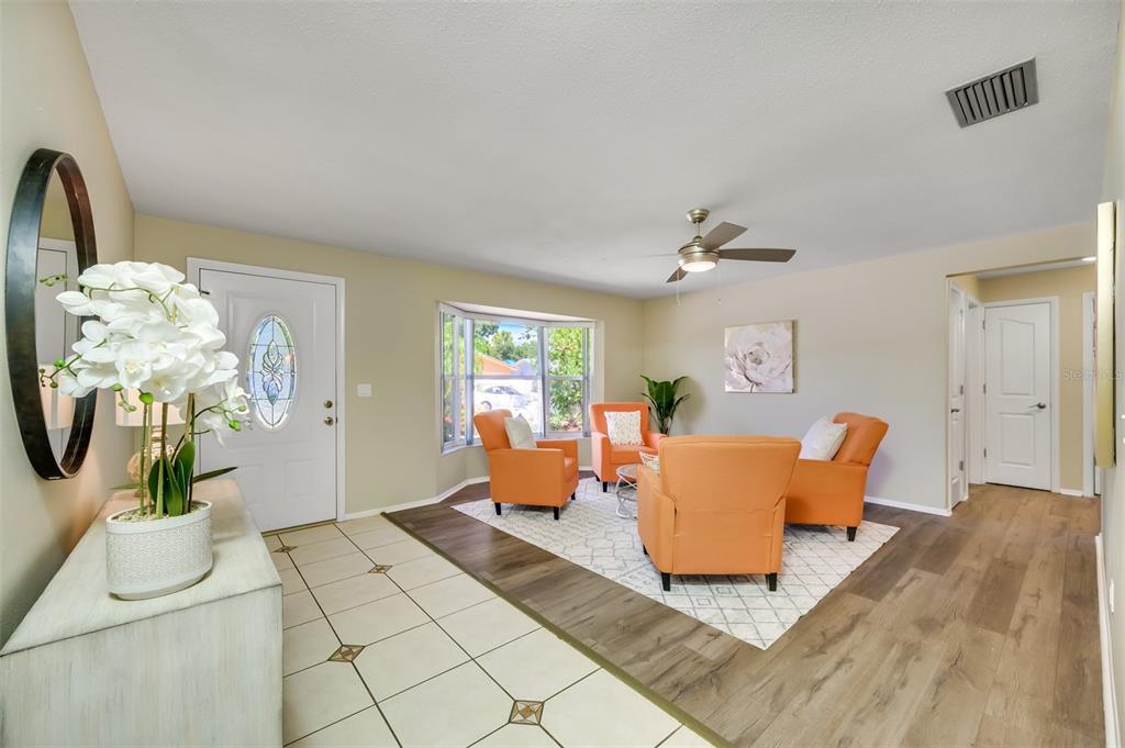 11290 142nd Street North Largo, FL 33774 - Photo 12 of 90 a living room with furniture a chandelier and a window