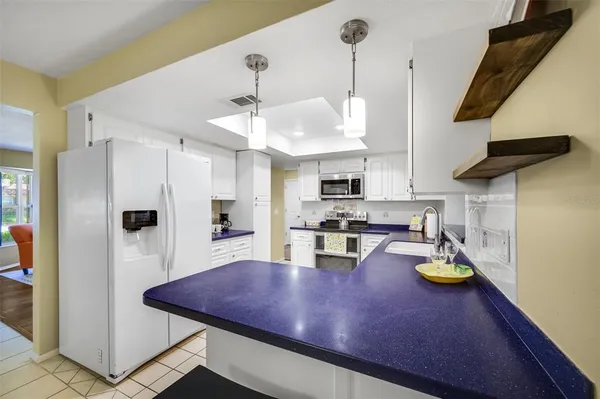 a bedroom with a large bed lamps and a large mirror on dresser