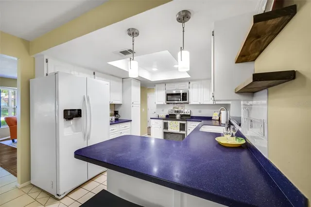 a bedroom with a large bed lamps and a large mirror on dresser