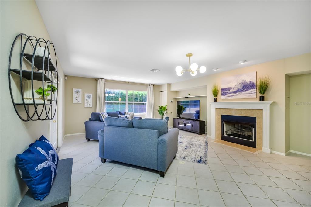 11290 142nd Street North Largo, FL 33774 - Photo 27 of 90 a living room with furniture a fireplace and a flat screen tv