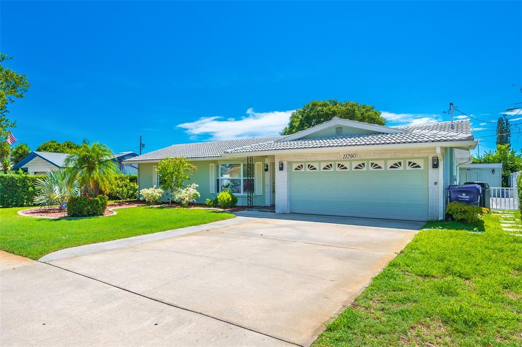11290 142nd Street North Largo, FL 33774 - Photo 3 of 90 a view of a house with a yard and potted plants