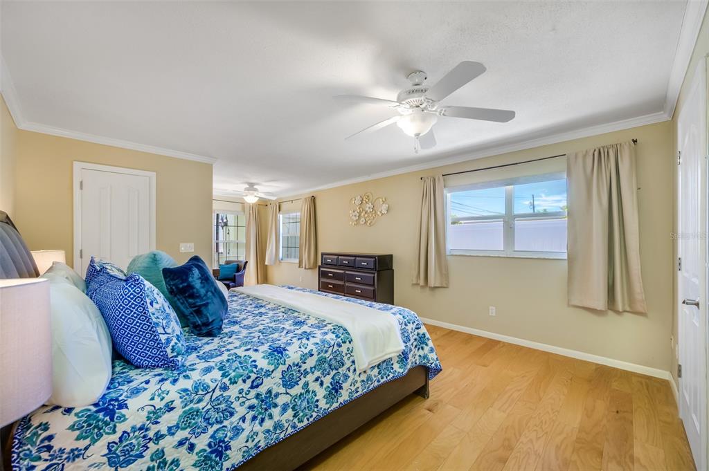 11290 142nd Street North Largo, FL 33774 - Photo 34 of 90 a bedroom with a large bed and a chandelier