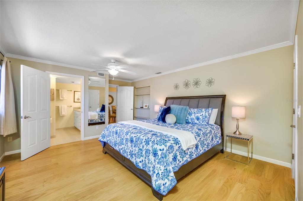 11290 142nd Street North Largo, FL 33774 - Photo 36 of 90 a bedroom with a large bed lamps and a large mirror on dresser