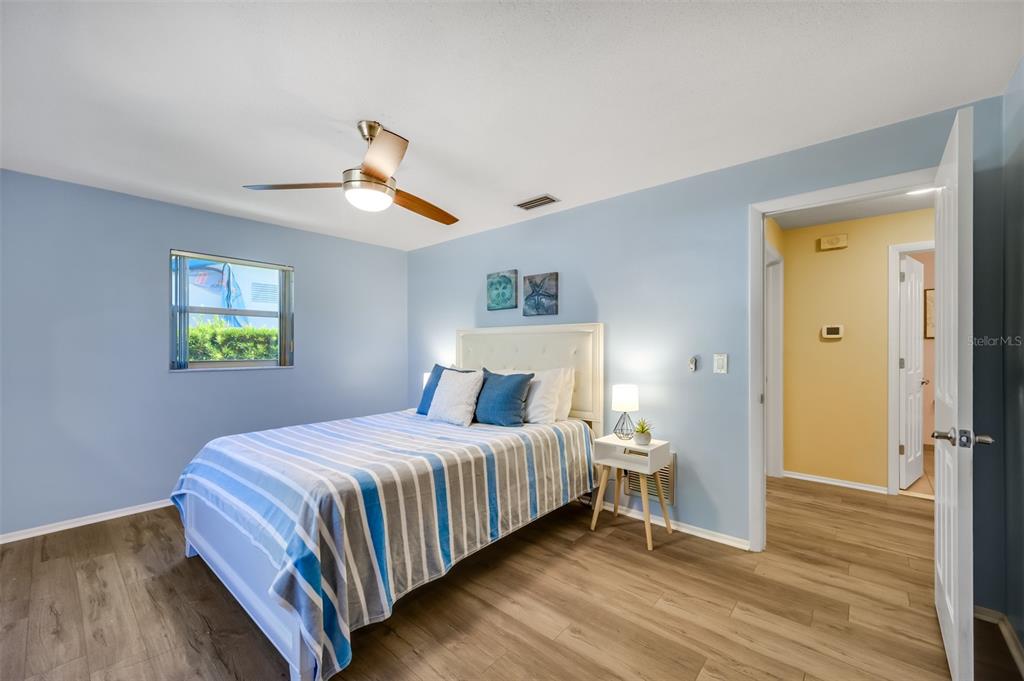 11290 142nd Street North Largo, FL 33774 - Photo 43 of 90 a bedroom with a bed and wooden floor