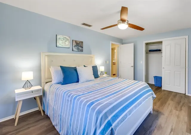 an aerial view of residential houses with outdoor space and trees