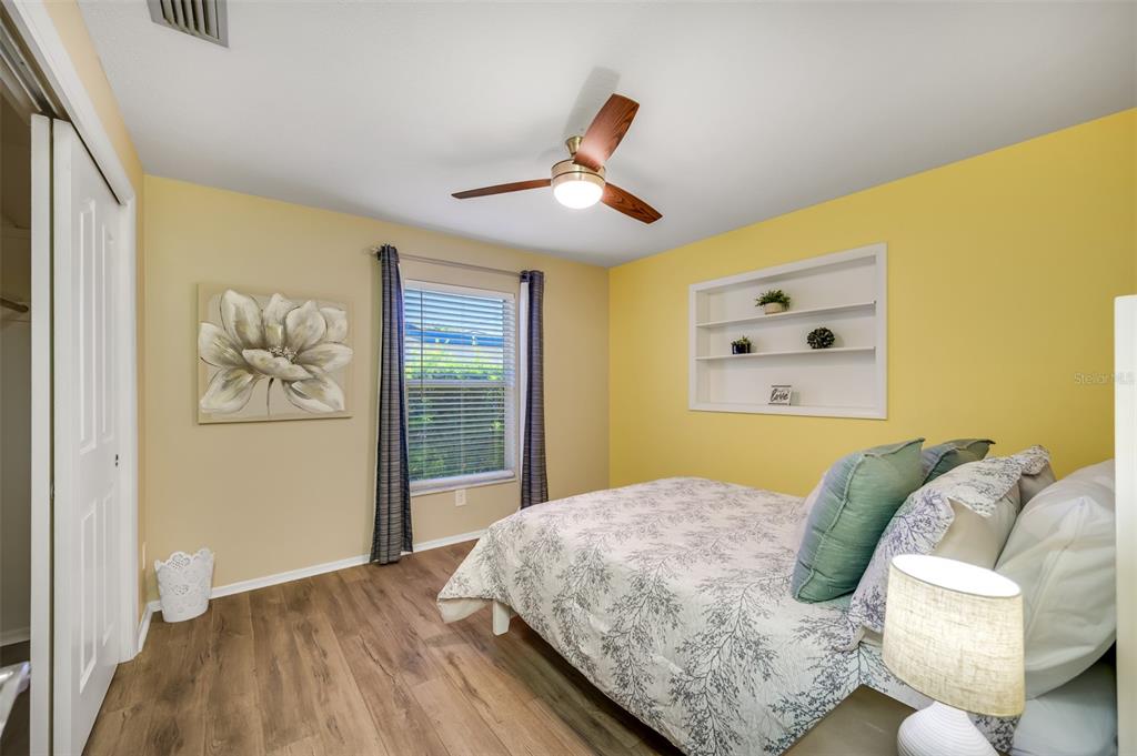 11290 142nd Street North Largo, FL 33774 - Photo 45 of 90 a bedroom with a bed and wooden floor