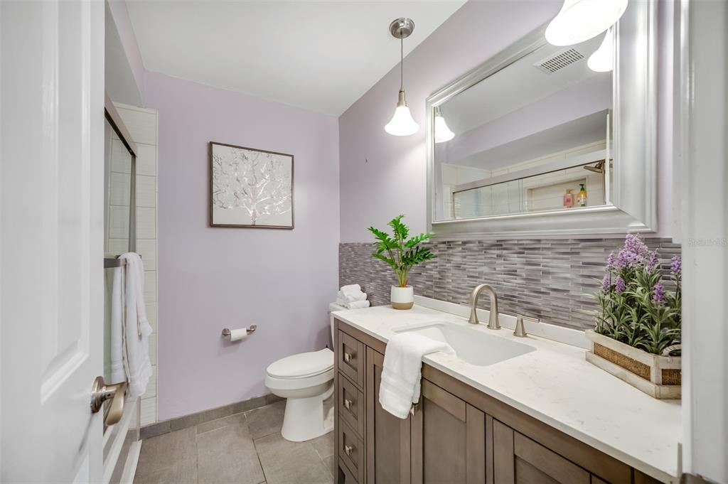11290 142nd Street North Largo, FL 33774 - Photo 48 of 90 a bathroom with a sink a toilet and large mirror
