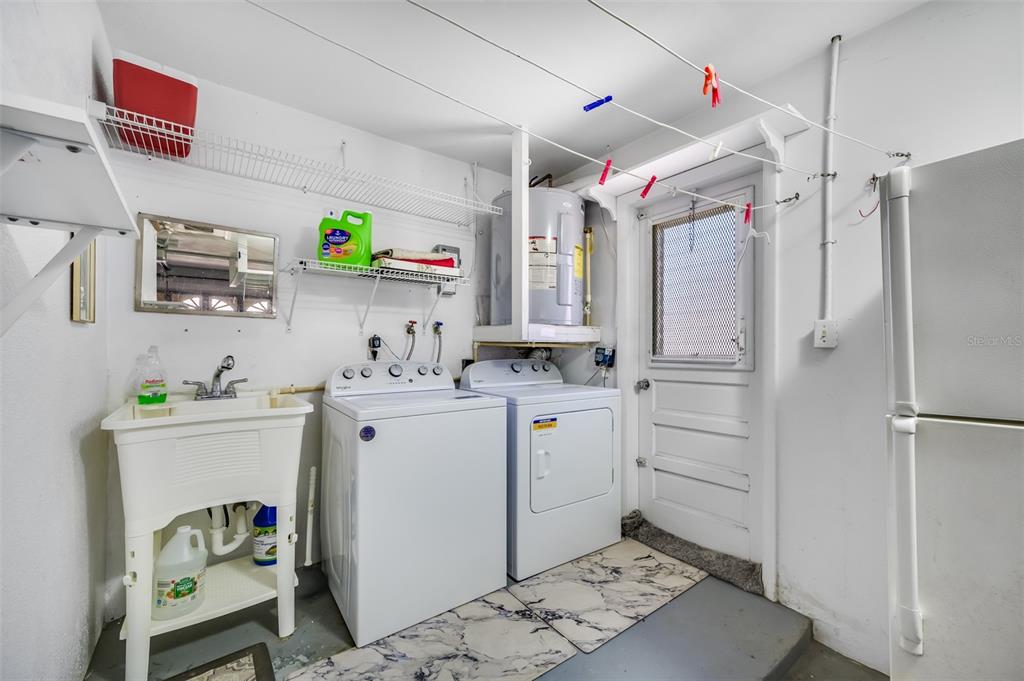 11290 142nd Street North Largo, FL 33774 - Photo 50 of 90 a utility room with cabinets washer and dryer