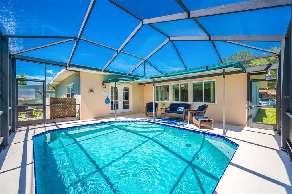 11290 142nd Street North Largo, FL 33774 - Photo 9 of 90 a view of a backyard with table and chairs under an umbrella