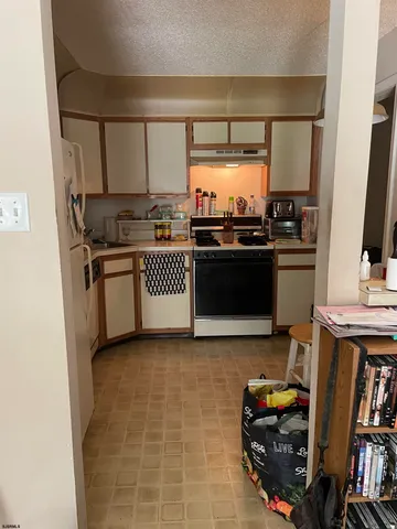 a kitchen with stainless steel appliances granite countertop a stove and a refrigerator