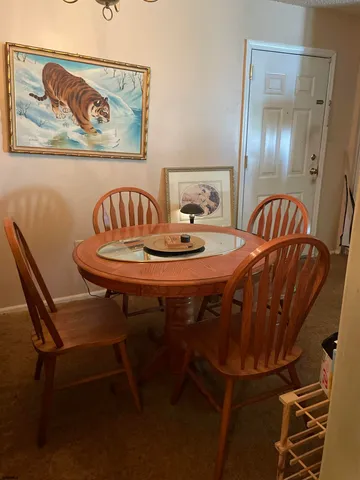 a dining room with furniture and mirror