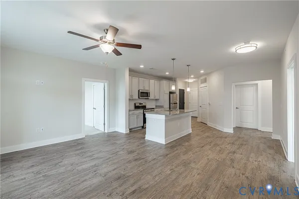 a kitchen with stainless steel appliances granite countertop a stove and a refrigerator