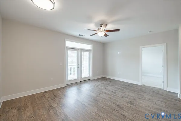 a kitchen with kitchen island a sink and wooden floor
