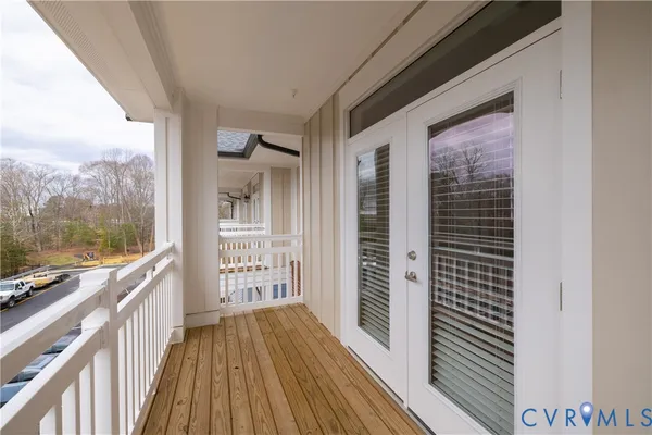 a view of a balcony with mountain view and wooden floor