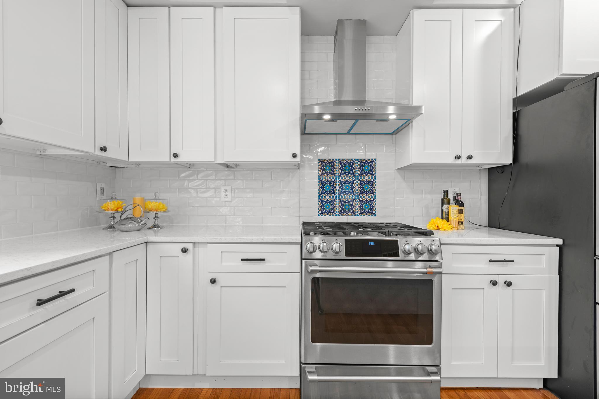 403 Madison Street Herndon, VA 20170 - Photo 12 of 63 a kitchen with stainless steel appliances granite countertop a stove and white cabinets